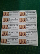 Load image into Gallery viewer, Sheet of printed labels with 'Service is Due' text and images on a green cutting mat.