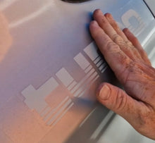 Load image into Gallery viewer, Hand touching a Silver tubro decals on white surface.