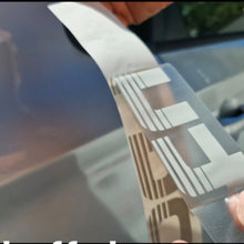 Load image into Gallery viewer, Person applying a car wrap film with a logo on a vehicle Silver tubro decals