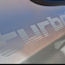Load image into Gallery viewer, Car window with 'Turbo' decal on a reflective surface