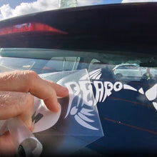 Load image into Gallery viewer, Spearo Sticker Hand holding a white decal with text and graphics, approaching a car window.