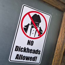 Load image into Gallery viewer, Sticker with a humorous message 'No Dickheads Allowed!' on a reflective surface.