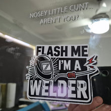 Load image into Gallery viewer, Sticker with text 'Flash me I'm a welder' held up to a mirror with text on it.