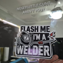 Load image into Gallery viewer, Sticker with text 'Flash me I'm a welder' held up to a mirror with text on it.