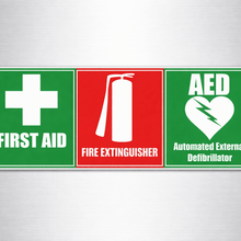 Load image into Gallery viewer, Three safety decals all in one for first aid, fire extinguisher, and AED on a gray background