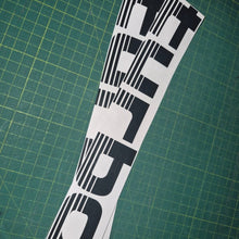 Load image into Gallery viewer, Turbo decal on a green cutting mat