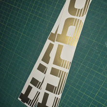 Load image into Gallery viewer, Turbo decal on a green cutting mat