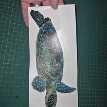 Load image into Gallery viewer, Hand holding a turtle decal on a cutting mat