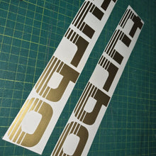 Load image into Gallery viewer, Two 'Turbo' decal stickers on a green cutting mat.