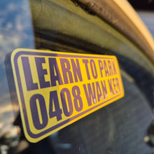 Load image into Gallery viewer, Yellow and black sticker on a vehicle window with text 'LEARN TO PARK 0408 WAN KER'.
