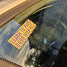 Load image into Gallery viewer, Yellow sticker on a car window with text 'LEARN TO PARK WANKER'.