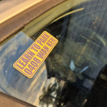 Load image into Gallery viewer, Yellow sticker on a car window with text 'LEARN TO PARK WANKER'.
