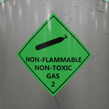 Load image into Gallery viewer, Close-up on compressed gas cylinder