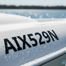 Load image into Gallery viewer, Close-up vinyl rego letters on boat hull