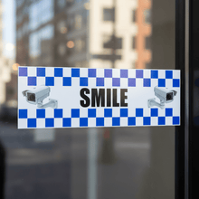 Load image into Gallery viewer, Detailed close-up of the 'SMILE You're on Camera' message and graphic elements on a security STICKER