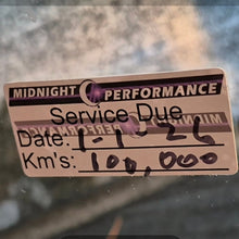 Load image into Gallery viewer, double sided Service due sticker on a car window with 'Midnight Performance' branding