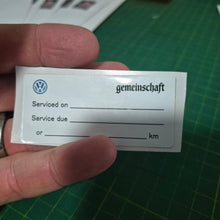 Load image into Gallery viewer, Close-up of 65x30mm double-sided service due sticker showing reverse side with service date and business contact information