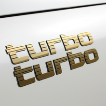 Load image into Gallery viewer, Gold Turbo sticker close-up white LandCruiser
