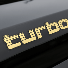 Load image into Gallery viewer, Gold Turbo sticker on black 4WD panel
