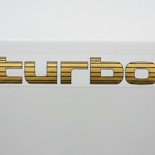 Load image into Gallery viewer, Gold Turbo sticker white panel flat lighting