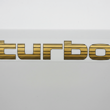 Load image into Gallery viewer, Gold Turbo sticker white panel flat lighting