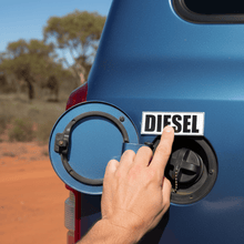 Load image into Gallery viewer, Hand applying diesel sticker to 4WD fuel cap door