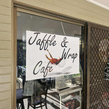 Load image into Gallery viewer, Glass door with 'Jaffle & Wrap Cafe' sign, showing interior of a cafe.