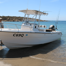 Load image into Gallery viewer, Rego sticker on fishing boat hull at ramp