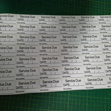 Load image into Gallery viewer, Sheet of 'Service Due' labels with pre-printed text on a green cutting mat.