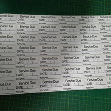 Load image into Gallery viewer, Sheet of 'Service Due' labels with pre-printed text on a green cutting mat.