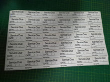 Load image into Gallery viewer, Sheet of 'Service Due' labels with pre-printed text on a green cutting mat.