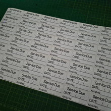 Load image into Gallery viewer, Sheet of labels with 'Service Due' text on a green cutting mat