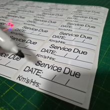 Load image into Gallery viewer, Sheet of labels with 'Service Due' text on a green cutting mat.