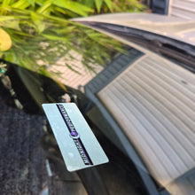 Load image into Gallery viewer, Car Service due decal with a brand label on a car interior window seen from the outside of the vehicle