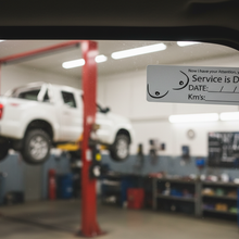 Load image into Gallery viewer, Service due sticker on ute windscreen in workshop