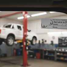Load image into Gallery viewer, Service due sticker on ute windscreen in workshop