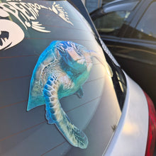 Load image into Gallery viewer, Car window with a large blue and green Turtle decal on a white car.