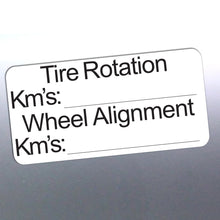 Load image into Gallery viewer, Label for tire rotation and wheel alignment with fields for kilometers on a reflective surface.