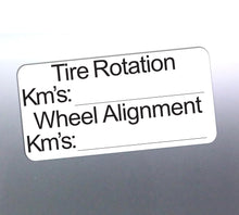 Load image into Gallery viewer, Label for tire rotation and wheel alignment with fields for kilometers on a reflective surface.