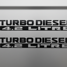 Load image into Gallery viewer, Two black Turbo Diesel 4.2 Litre stickers stacked