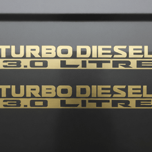 Load image into Gallery viewer, Two matte gold Turbo Diesel 3.0 Litre stickers stacked
