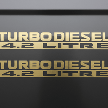 Load image into Gallery viewer, Two matte gold Turbo Diesel 4.2 Litre stickers stacked