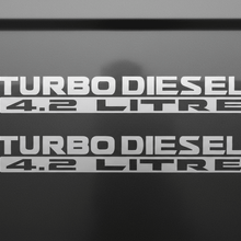 Load image into Gallery viewer, Two satin silver Turbo Diesel 4.2 Litre stickers stacked