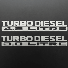 Load image into Gallery viewer, Two silver-grey Turbo Diesel 3.0 Litre stickers stacked