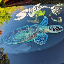 Load image into Gallery viewer, Turtle decal on a car window with a logo in the background