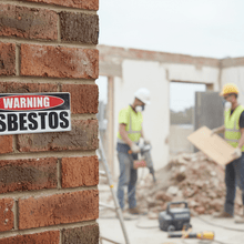 Load image into Gallery viewer, Warning Asbestos on brick wall