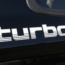 Load image into Gallery viewer, White 100 Series Turbo sticker on black vehicle panel