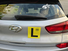 Load image into Gallery viewer, Hyundai car with a yellow learner's license plate on the back