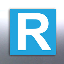 Load image into Gallery viewer, A blue rectangular magnet with the letter 'R' in the center, representing a magnetic badge for drivers with a suspended license.