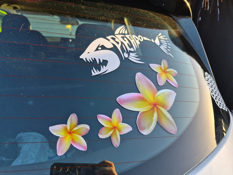 Car window with a yellow frangipani pink flowers